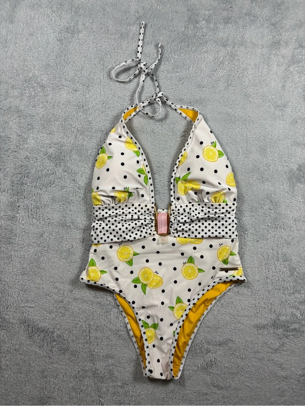 Juicy Couture yellow and white polka dot one piece swimsuit.
